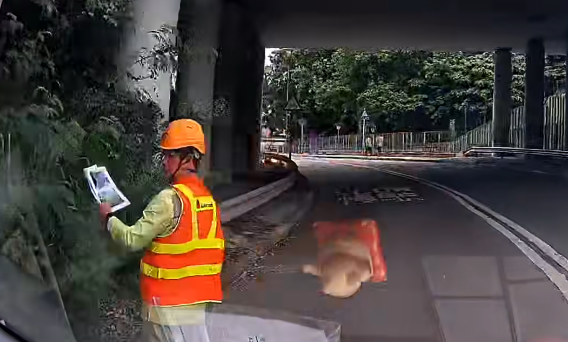 一輛車沿元朗新潭路往米埔村方向行駛期間,在一個彎位突然發見一名身穿反光衣及安全帽的工人站在馬路中央工作,幸司機及時發現並扭軚閃避。(車cam L(香港群組)FB)