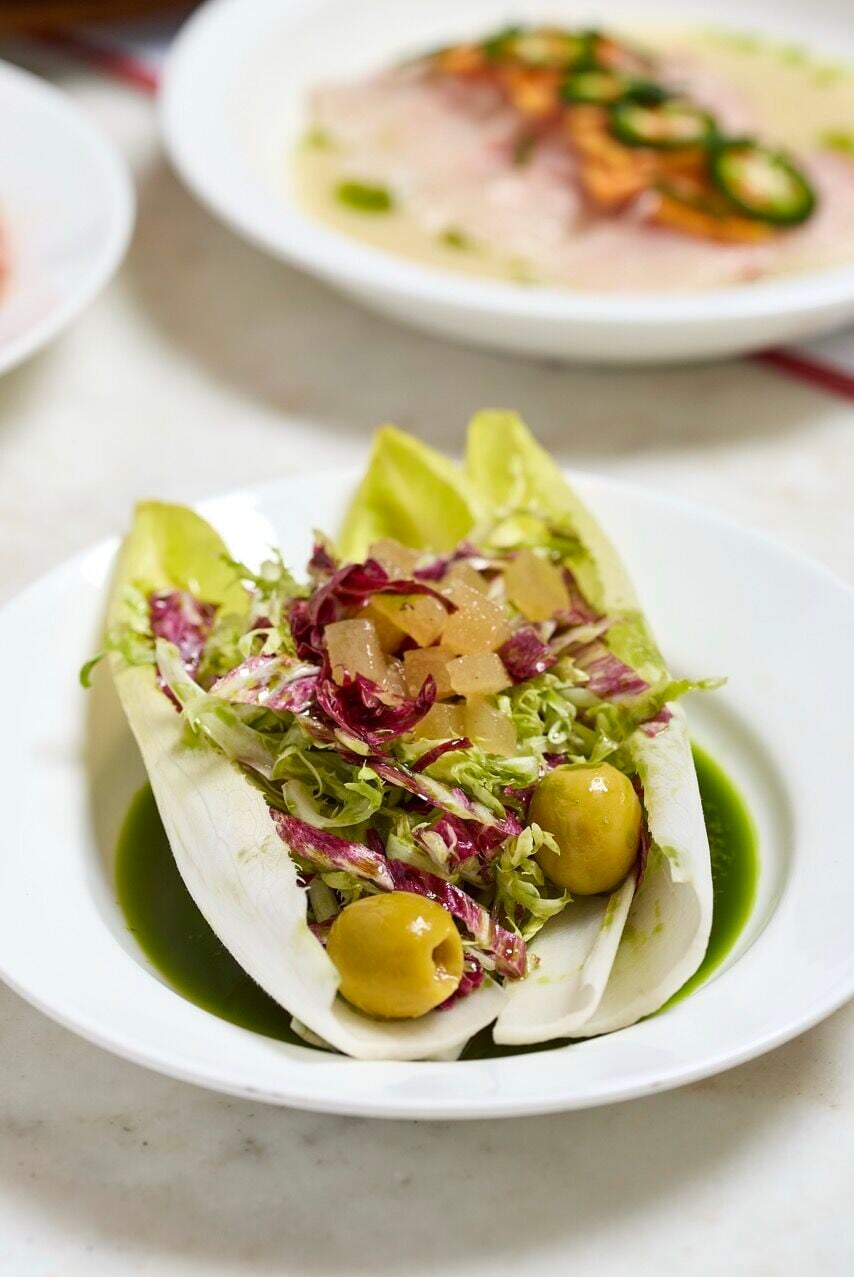 Qué Pasa Free flow Tapas Club Endive Salad, radicchio, olives, quince paste, peppers, parsley dressing Large