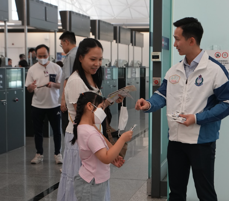 入境處在香港國際機場派發傳單,提醒市民外遊時、尤其是暑假期間的旅遊旺季的注意事項。(入境處提供)