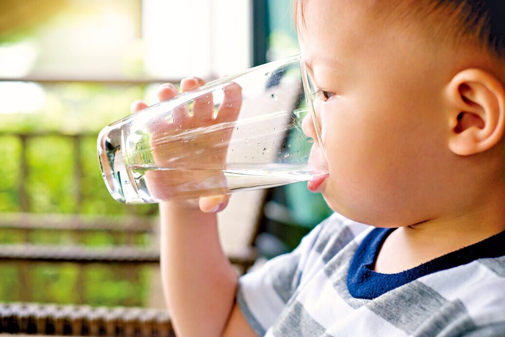 Health 3col little baby boy drinking glass of water 1062571014