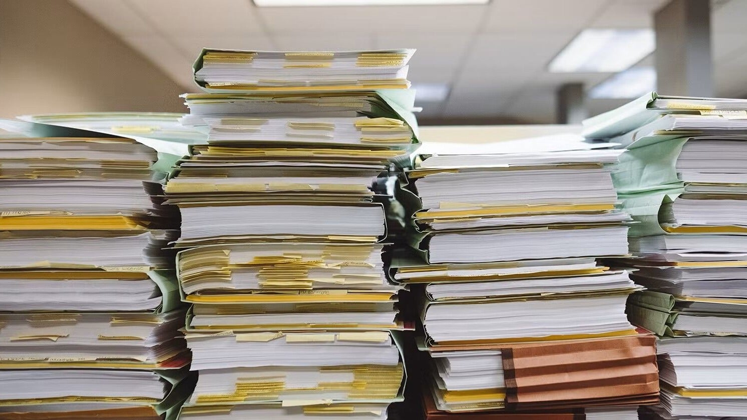 Four stacks of documents from multiple projects