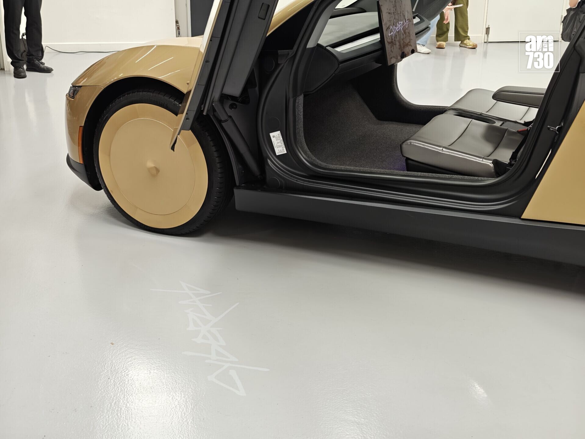 Tesla Cybercab車門投影Cybercab標誌在地上。