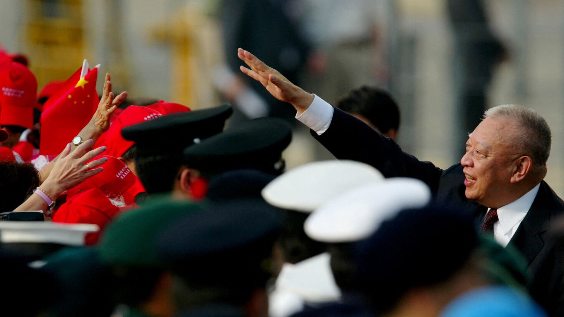 FILE PHOTO Hong Kong Chief Executive Tung Chee hwa waves to residents as they attend a flag raising ceremony to mark the seventh anniversary of the handover of Hong Kong to China, in Hong Kong, China Jul