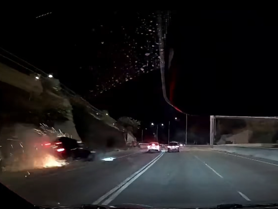 黑色私家車失控撞向石壆並冒出火花。(網上影片截圖)