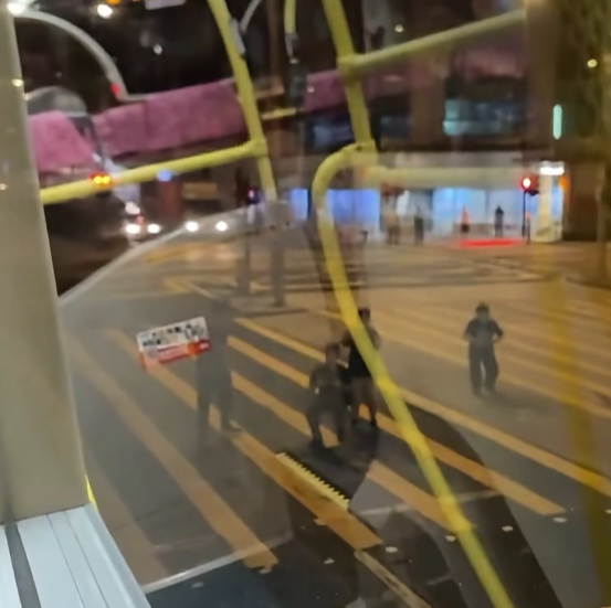 一名男子在晚上的彌敦道行車線上跑出馬路狂奔近百米,疑為會合友人一同拍攝巴士。(Facebook群組「車cam L(香港群組)」)