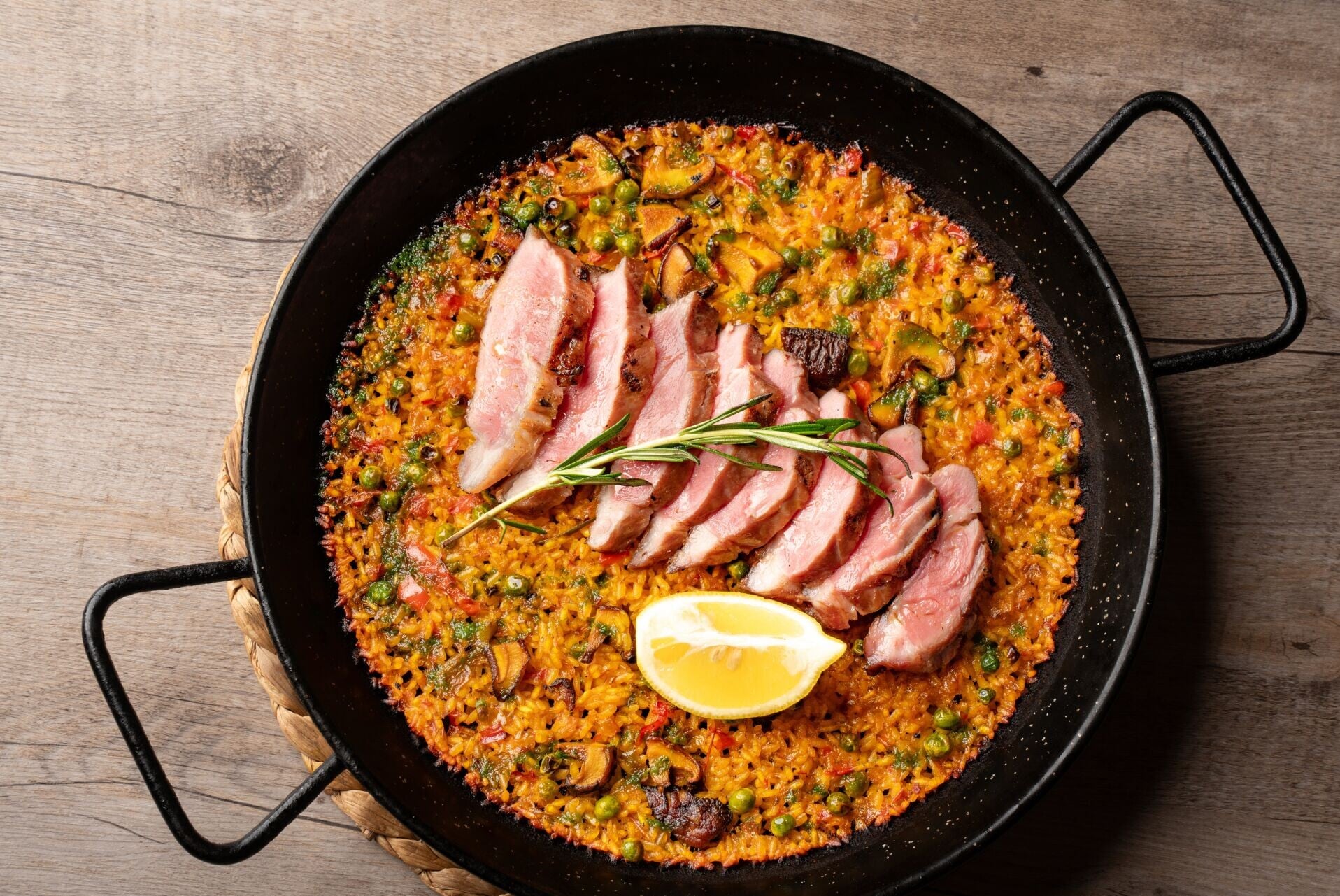 MAIN Paella de Pluma Iberica Savory paella With tender Ibérico pork plurna, mushrooms & fresh rosemary 5
