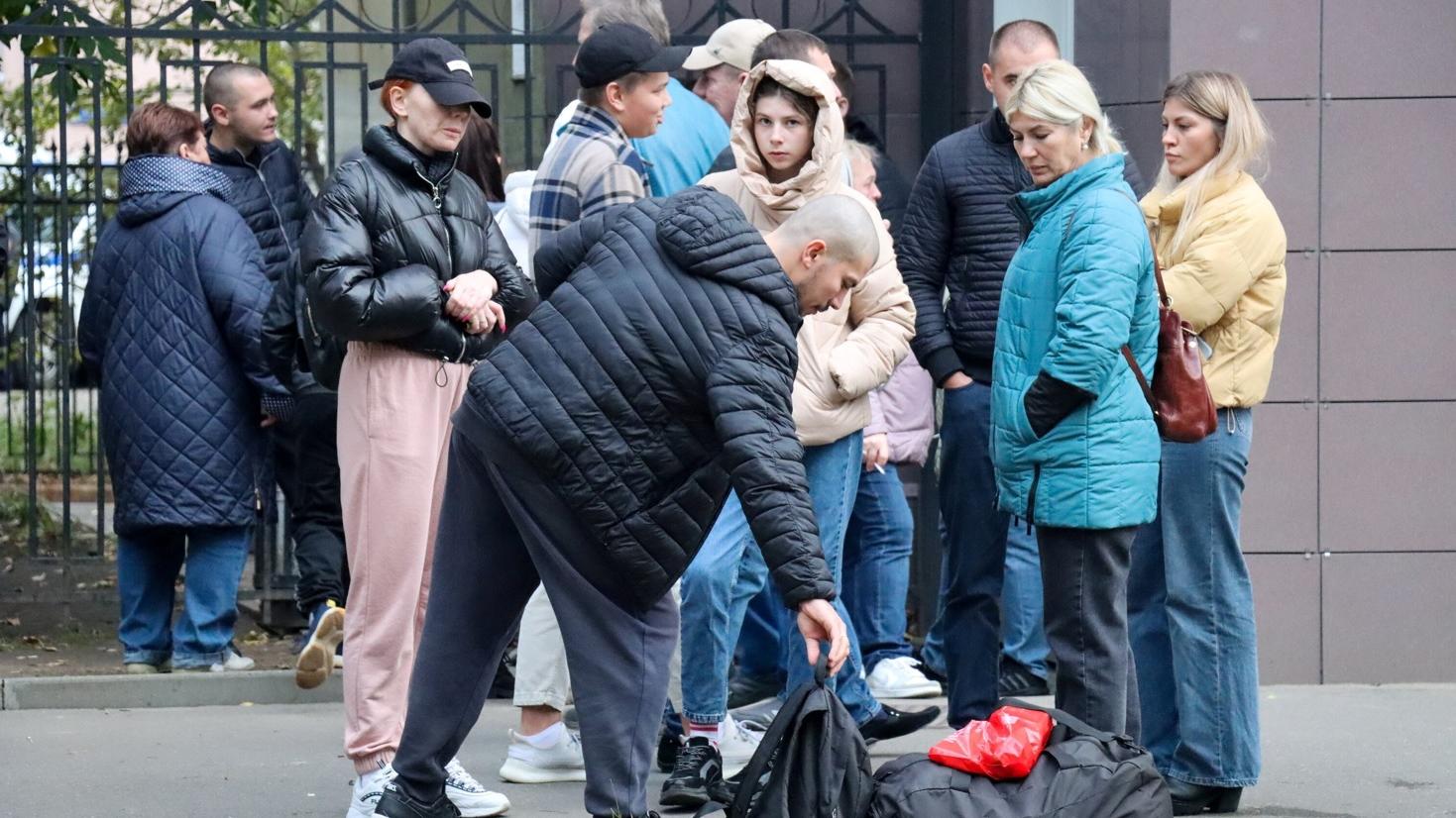 一名男子被徵召入伍，在莫斯科軍需處外與親友道別。(路透社)