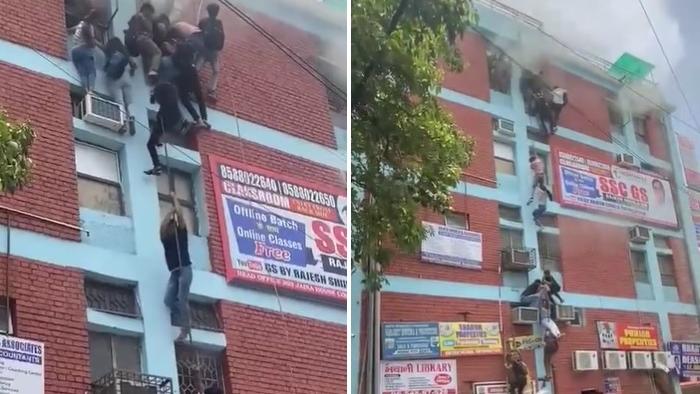 學生抓著電線滑下，驚險萬分，圍觀民眾紛紛舉起手機拍攝。(互聯網)