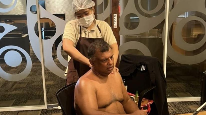 費爾南德斯赤裸上身，一邊按摩、一邊開會。(互聯網)