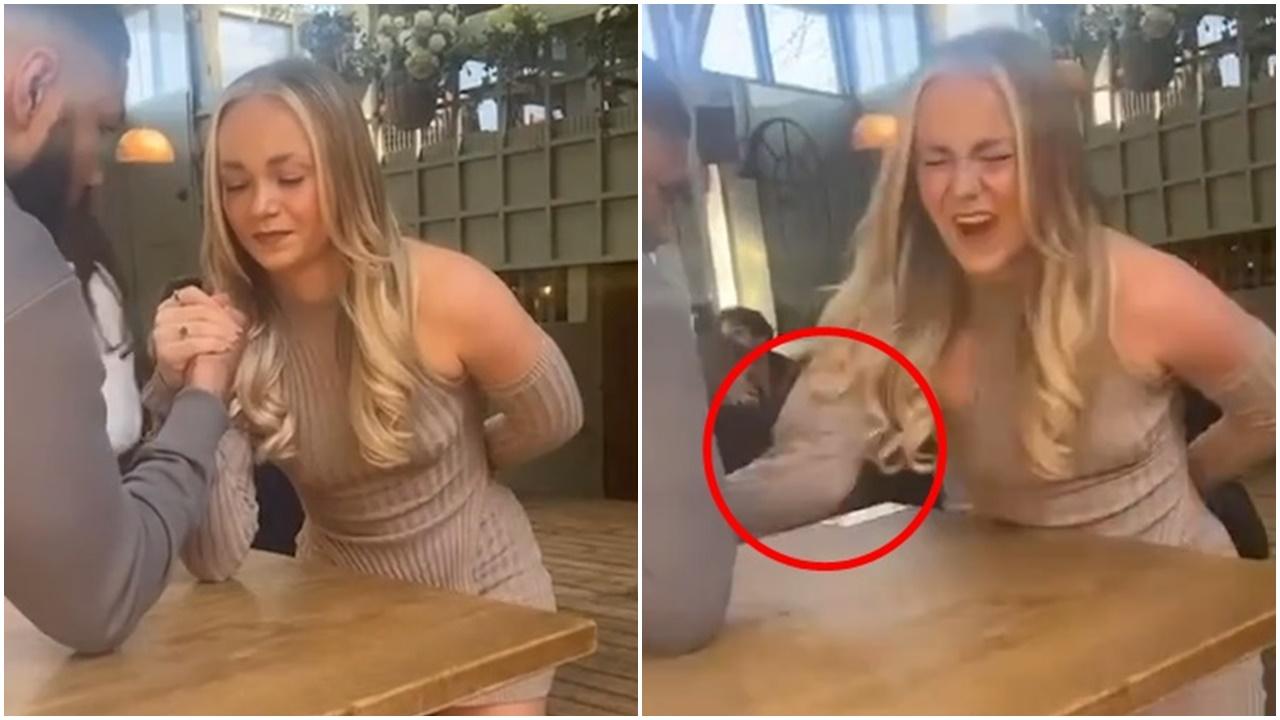 英女酒吧與猛男拗手瓜，啪一聲手臂變形痛得面容扭曲。(LAD)