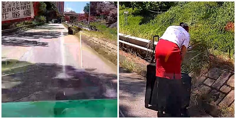 一輛綠色的士於屯門青雲路行駛期間，前方突出現一名帶行李喼的國泰女空姐。(影片截圖)