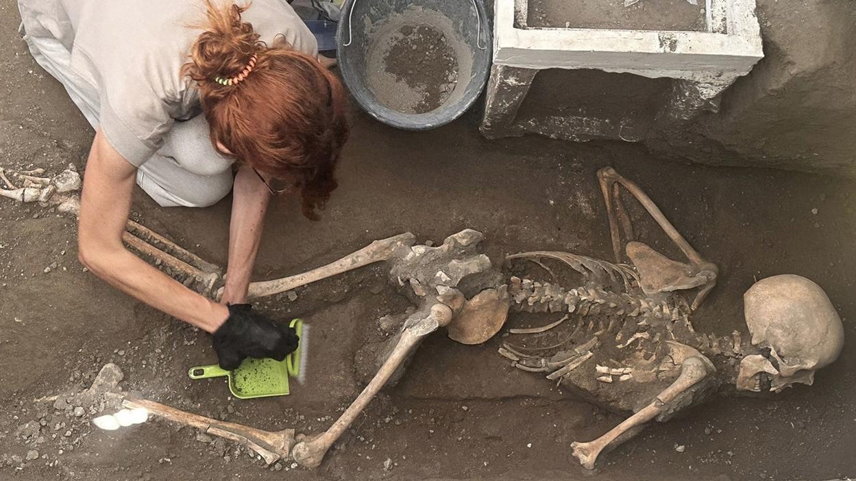 考古學家仔細挖掘遺骸。(路透社)