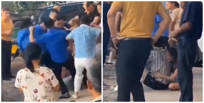  江西省撫州市東鄉區一間特色粉店門前，多名身穿城管制服的人員，圍毆倒地的兩名店主。(影片截圖)