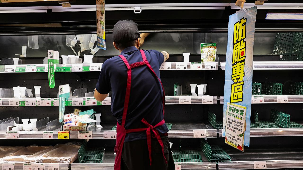 山陀兒逼近台灣，在高雄，超市員工整理被掃清的貨架。（路透社）