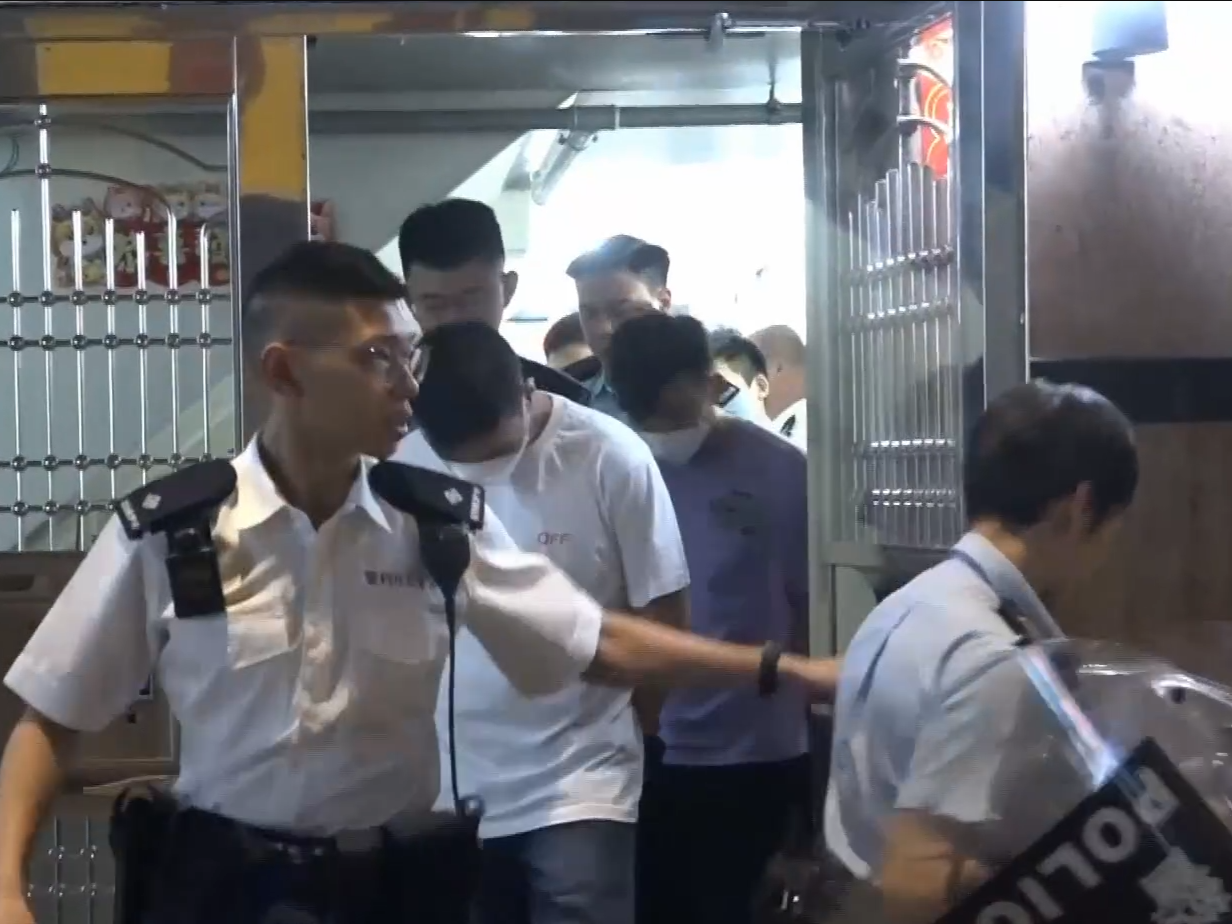 旺角男子捱斬頭腳浴血倒卧走廊，警持盾上樓拘4男。(有線新聞截圖)