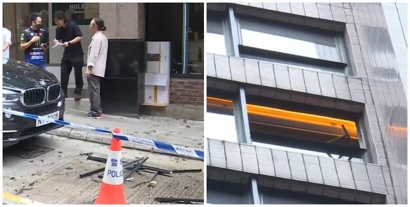 中環士丹利街50號一幢商業大廈有鋁窗從高處墜下，3輛私家車及一名女途人被碎片濺中，女子手傷經救護員治理後毋須送院。(有線新聞畫面)