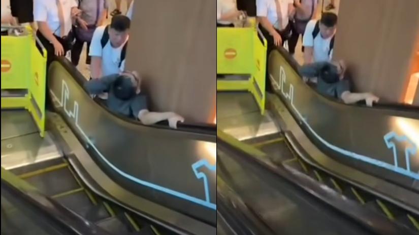 男子被夾在扶手電梯。(網上影片截圖)