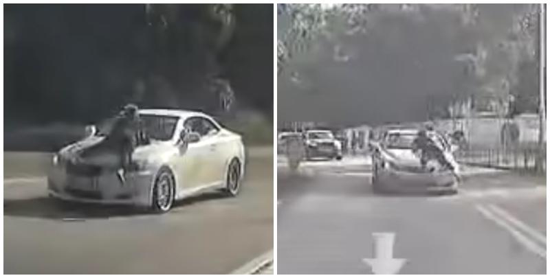 片段中一輛白色私家車沿粉錦公路行駛，一名穿黑衣的人伏在該車頭上(影片截圖)