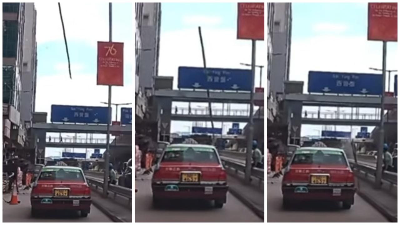 車Cam直擊，干諾道西天降棚竹直插的士，險被擊中工人檢走竹支惹爭議。(FB/車cam L（香港群組）)