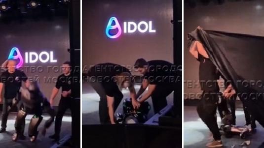 左至右：機械人在台上跌倒，工作人員立即將它扶起，又拉起黑布遮擋。(互聯網)